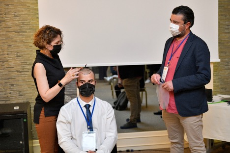 Hands-on hair transplant group training on a live patient